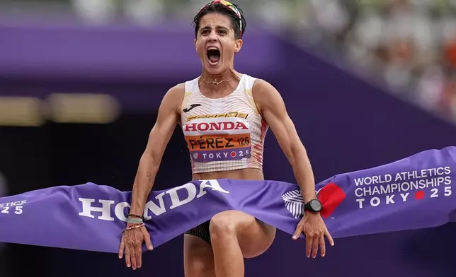 Spain's Maria Perez celebrates after winning the gold medal in the women's 20 kilometers race walk at the World Athletics Championships in Tokyo, Saturday, Sept. 20, 2025. (AP Photo/Petr David Josek)