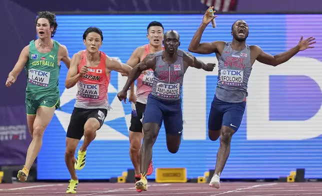 Britain's Jona Efoloko reacts as he fails to hand the baton in time to Britain's Eugene Amo-Dadzie in a men's 4 X 100 meters relay heat at the World Athletics Championships in Tokyo, Saturday, Sept. 20, 2025. (AP Photo/Petr David Josek)