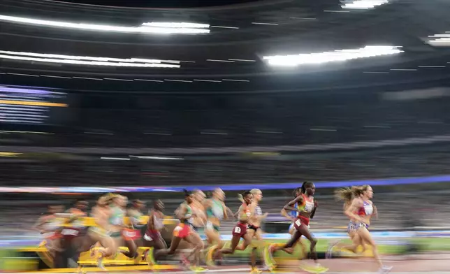 Athletes compete in the the women's 5,000 meters final at the World Athletics Championships in Tokyo, Saturday, Sept. 20, 2025. (AP Photo/Petr David Josek)
