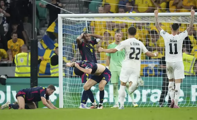 Slovienian players celebrate after scoring an equalizer during the World Cup qualifying soccer match between Slovenia and Sweden at the Stozice stadium in Ljubljana, Slovenia, Friday, Sept. 5, 2025. (AP Photo/Darko Bandic)