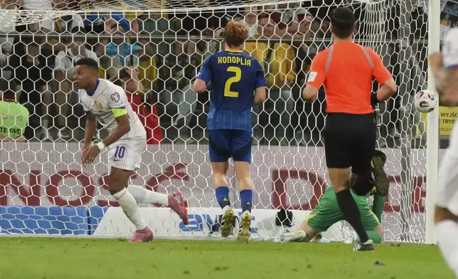 France's Kylian Mbappe, left, celebrates after scoring his side's second goal during the 2026 FIFA World Cup qualifying soccer match between Ukraine and France at Tarczynski Arena in Wroclaw, Poland, Friday, Sept. 5, 2025. (AP Photo/Czarek Sokolowski)