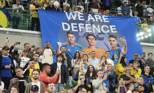 Ukraine fans wait for the start of the 2026 FIFA World Cup qualifying soccer match between Ukraine and France at Tarczynski Arena in Wroclaw, Poland, Friday, Sept. 5, 2025. (AP Photo/Czarek Sokolowski)