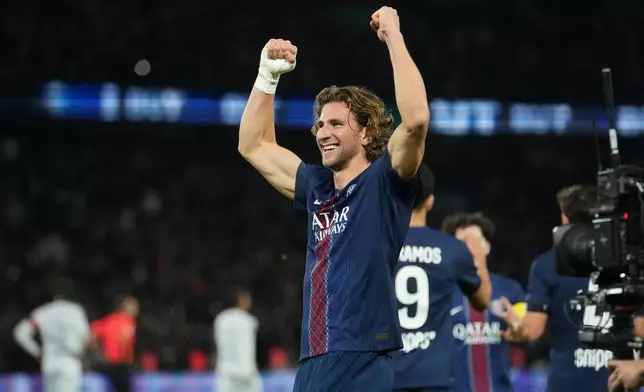 PSG's Illya Zabarnyi celebrates after scoring the opening goal during the French League One soccer match between Paris Saint-Germain and Auxerre at the Parc des Princes in Paris, Saturday, Sept. 27, 2025. (AP Photo/Thibault Camus)