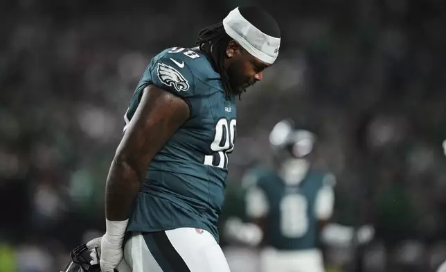 Philadelphia Eagles defensive tackle Jalen Carter walks off the field after being disqualified for unsportsman like conduct before an NFL football game against the Dallas Cowboys Thursday, Sept. 4, 2025, in Philadelphia. (AP Photo/Matt Slocum)