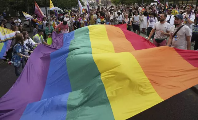 Participants hold up a rainbow flag during the Gay Pride march in Belgrade, Serbia, Saturday, Sept. 6, 2025. (AP Photo/Darko Vojinovic)
