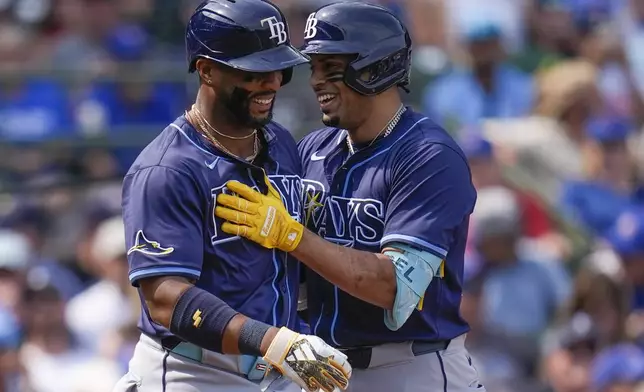 Tampa Bay Rays designated hitter Christopher Morel, right, celebrates his three-run home run with Yandy Díaz during the first inning of a baseball game against the Chicago Cubs, Friday, Sept. 12, 2025, in Chicago. (AP Photo/Erin Hooley)