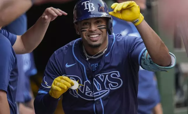 Tampa Bay Rays designated hitter Christopher Morel (24) celebrates in the dugout after hitting a three-run home run during the first inning of a baseball game against the Chicago Cubs, Friday, Sept. 12, 2025, in Chicago. (AP Photo/Erin Hooley)