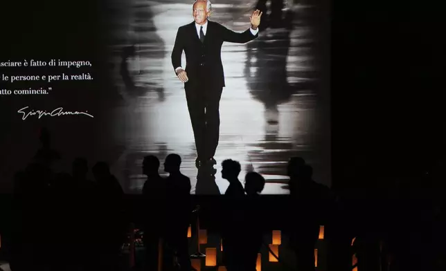 People pay their respects to fashion designer Giorgio Armani, lying in state at the Armani/Teatro in Milan, northern Italy, Saturday, Sept. 6, 2025. (AP Photo/Antonio Calanni)