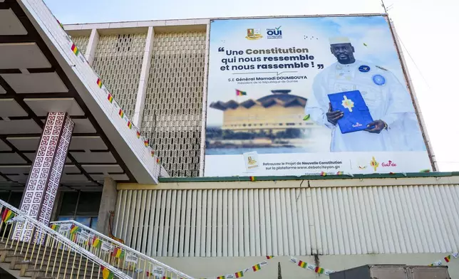 CORRECTS TITLE OF MILITARY LEADER A large campaign banner showing Guinea's interim president, Gen. Mamadi Doumbouya, is displayed on a public building in Conakry, Guinea, Wednesday, Sept. 17, 2025. (AP Photo/Misper Apawu)
