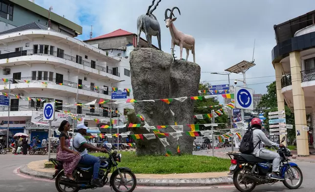 Motorcycles travel through a roundabout in Conakry, Guinea, Friday, Sept. 19, 2025. (AP Photo/Misper Apawu)