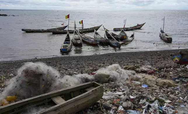 Fishing boats are anchored along the shore in Conakry, Guinea, Friday, Sept. 19, 2025 (AP Photo/Misper Apawu)