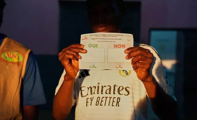 Officials count ballots at a polling station as polls close during the constitutional referendum in Conakry, Guinea, Sunday, Sept. 21, 2025. (AP Photo/Misper Apawu)