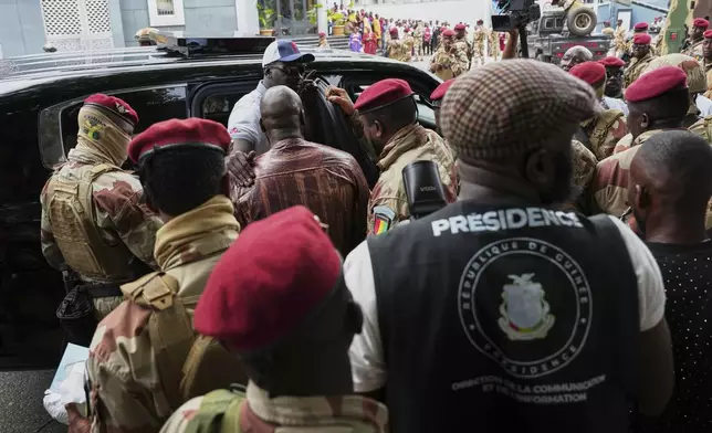 Guinea's interim President, Gen. Mamadi Doumbouya, departs after casting his vote in the constitutional referendum, in Conakry, Guinea, Sunday, Sept. 21, 2025. (AP Photo/Misper Apawu)