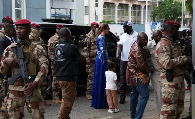 Guinea's interim President, Gen. Mamadi Doumbouya, arrives with his family to cast his vote in the constitutional referendum, in Conakry, Guinea, Sunday, Sept. 21, 2025. (AP Photo/Misper Apawu)