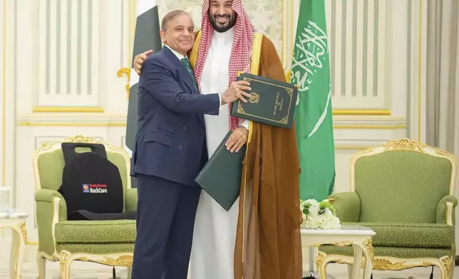 This handout photograph released by the state-run Saudi Press Agency shows Pakistani Prime Minister Shehbaz Sharif, left, embracing Saudi Arabia's Crown Prince Mohammed bin Salman after signing a joint defense pact in Riyadh, Saudi Arabia, Wednesday, Sept. 17, 2025. (Saudi Press Agency via AP)