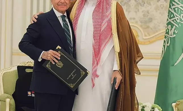 In this photo released by Pakistan's Press Information Department, Saudi Arabia's Crown Prince Mohammed bin Salman, right, and Pakistan's Prime Minister Shehbaz Sharif pose for photograph after signing a mutual defense pact, in Riyadh, Saudi Arabia, Wednesday, Sept. 17, 2025. (Press Information Department via AP)
