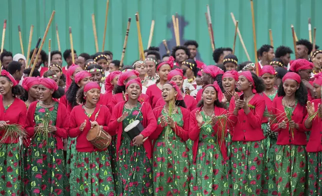Ethiopian women wearing traditional clothes sing on the street as the Grand Ethiopian Renaissance Dam is inaugurated in Addis Ababa, Ethiopia, Tuesday, Sept. 9, 2025. (AP Photo/Brian Inganga)