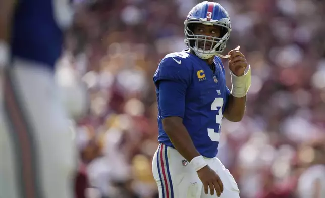 New York Giants quarterback Russell Wilson (3) looks up at the scoreboard during the second half of an NFL football game against the Washington Commanders, Sunday, Sept. 7, 2025, in Landover, Md. (AP Photo/Stephanie Scarbrough)