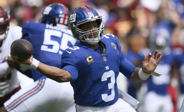 New York Giants quarterback Russell Wilson (3) passes the ball during the first half of an NFL football game against the Washington Commanders, Sunday, Sept. 7, 2025, in Landover, Md. (AP Photo/Nick Wass)