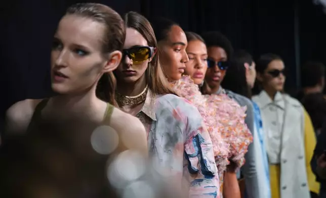 Models wear creations part of the Diesel's Spring Summer 2026 collection in the backstage ahead of the collection's show, in Milan, Italy, Tuesday, Sept. 23, 2025. (AP Photo/Antonio Calanni)
