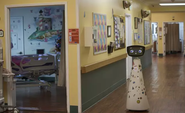 Robin the Robot, developed by Expper Technologies, visits patients' rooms at the HealthBridge Orange Specialty Pediatric Hospital in Orange, Calif., on Friday, Sept. 12, 2025. (AP Photo/Damian Dovarganes)