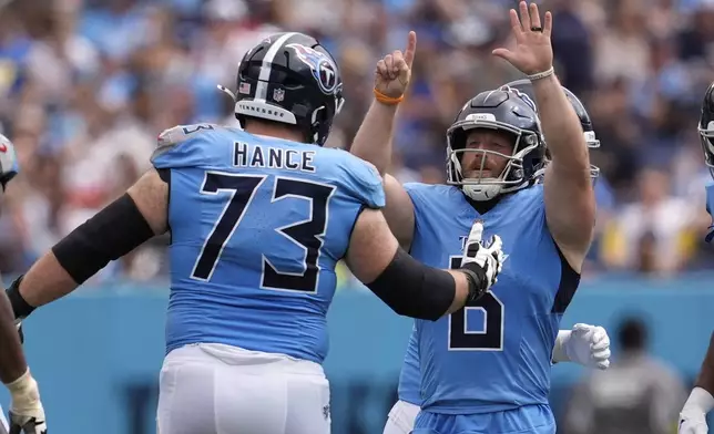 Tennessee Titans place kicker Joey Slye, right, celebrates a field goal with guard Blake Hance during the second half of an NFL football game against the Los Angeles Rams, Sunday, Sept. 14, 2025, in Nashville, Tenn. (AP Photo/George Walker IV)