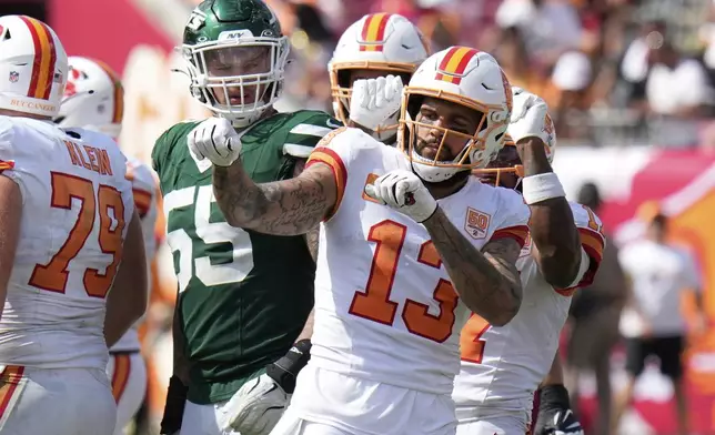 Tampa Bay Buccaneers wide receiver Mike Evans (13) celebrates a first down catch during the second half of an NFL football game against the New York Jets Sunday, Sept. 21, 2025, in Tampa, Fla. (AP Photo/Chris O'Meara)