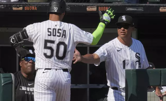 Chicago White Sox's Lenyn Sosa (50) is congratulated by manager Will Venable, right, after hitting a solo home run during the eighth inning of a baseball game against the New York Yankees in Chicago, Sunday, Aug. 31, 2025. (AP Photo/Nam Y. Huh)