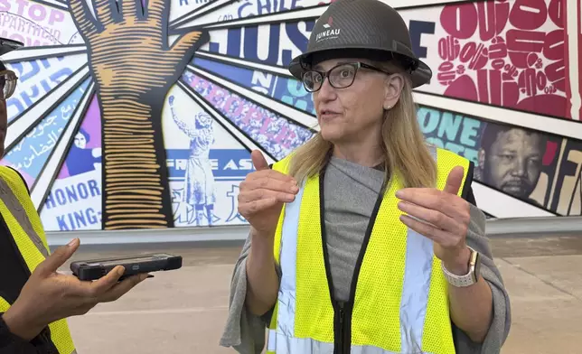 Jill Savitt, president and CEO of The National Center for Civil and Human Rights, describes the museum's expansion during a hard-hat tour, Wednesday, Sept. 10 in Atlanta. (AP Photo/Michael Warren)