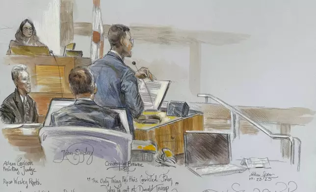 This courtroom sketch shows U.S. District Judge Aileen Cannon listening as prosecutor Christopher speaks during the trial of Ryan Routh, at left, who is charged with attempting to assassinate Donald Trump last year at a golf course in South Florida, Tuesday, Sept. 23, 2025, in Fort Pierce, Fla. (Lothar Speer via AP)