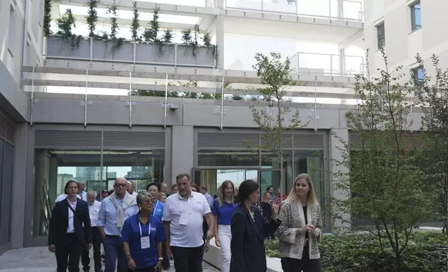 Executive Board and the IOC President Kirsty Coventry, right, visit the Olympic and Paralympic Village in Milan, Italy, Thursday, Sept. 18, 2025. (AP Photo/Antonio Calanni)