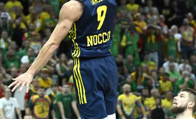 Sweden's Pelle Larsson, left, and Lithuania's Deividas Sirvydis, right, challenge for the ball during the Eurobasket, European Basketball Championship, group B match between Lithuania and Sweden in Tampere, Finland, Wednesday, Sept. 3, 2025. (Heikki Saukkomaa/Lehtikuva via AP)