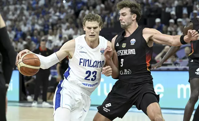 Finland's Lauri Markkanen with Germany's Franz Wagner, right, during the Eurobasket basketball match match between Finland and Germany in Tampere, Finland, Wednesday, Sept. 3, 2025. (Heikki Saukkomaa/Lehtikuva via AP)