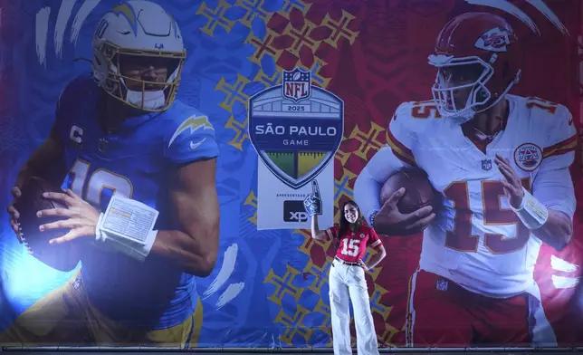 A fan poses before an NFL football game between the Kansas City Chiefs and the Los Angeles Chargers, Friday, Sept. 5, 2025, in Sao Paulo. (AP Photo/Andre Penner)