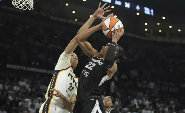 Las Vegas Aces center A'ja Wilson (22) looks to shoot against Indiana Fever forward Makayla Timpson, left, in the first half of Game 1 of a WNBA basketball playoff semifinals series Sunday, Sept. 21, 2025, in Las Vegas. (AP Photo/Candice Ward)