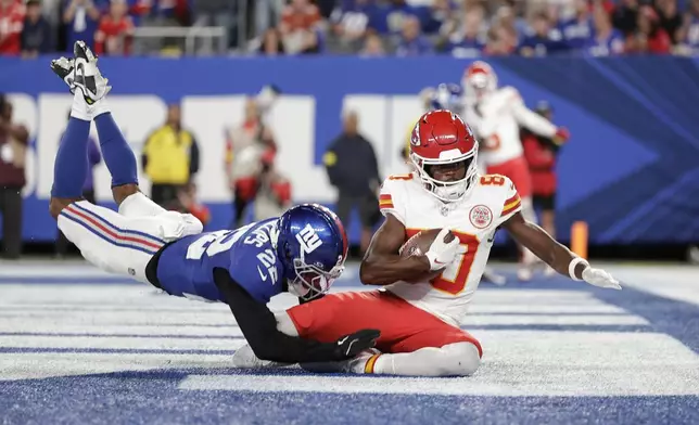 Kansas City Chiefs wide receiver Tyquan Thornton (80) scores as New York Giants cornerback Dru Phillips (22) defends during the second half of an NFL football game Sunday, Sept. 21, 2025, in East Rutherford, N.J. (AP Photo/Adam Hunger)