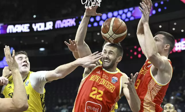 From left, Simon Birgander of Sweden, Igor Drobnjak and Dordije Jovanovic of Montenegro during the Eurobasket, European Basketball Championship group B match between Sweden and Montenegro in Tampere, Finland, Monday, Sept. 1, 2025. (Heikki Saukkomaa/Lehtikuva via AP)
