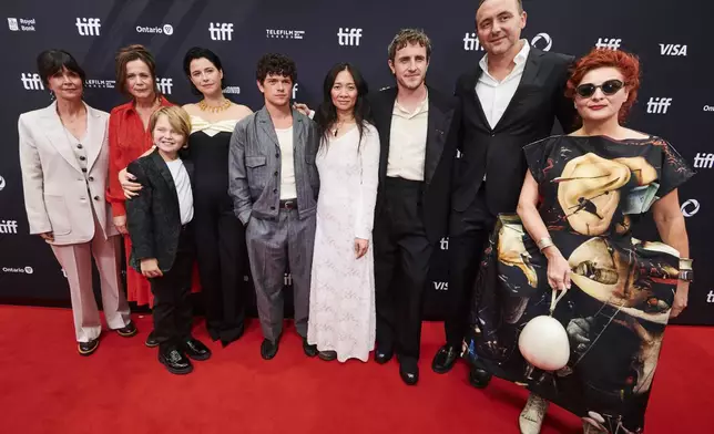 Producer Liza Marshall, left to right, actor Emily Watson, actor Jacobi Jupe, actor Jessie Buckley, actor Noah Jupe, director Chloé Zhao, actor Paul Mescal, producer Nic Gonda and costume designer Malgosia Turzanska are photographed on the red carpet for the film "Hamnet" during the Toronto International Film Festival in Toronto, on Sunday, Sept. 7, 2025. (Sammy Kogan/The Canadian Press via AP)