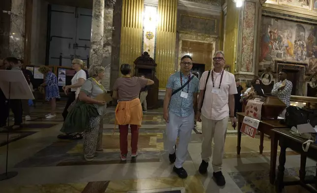 Justin Del Rosario, left, and John Capozzi arrive to attend attend a vigil prayer for members of the LGBTQ+ community in the Church of the Gesu' in central Rome, Friday, Sept. 5, 2025. (AP Photo/Andrew Medichini)