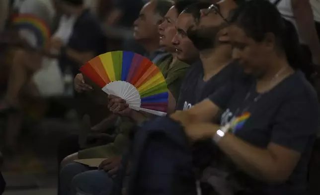 Members of the LGBTQ+ community attend a vigil prayer in the Church of the Gesu' in central Rome, Friday, Sept. 5, 2025. (AP Photo/Andrew Medichini)