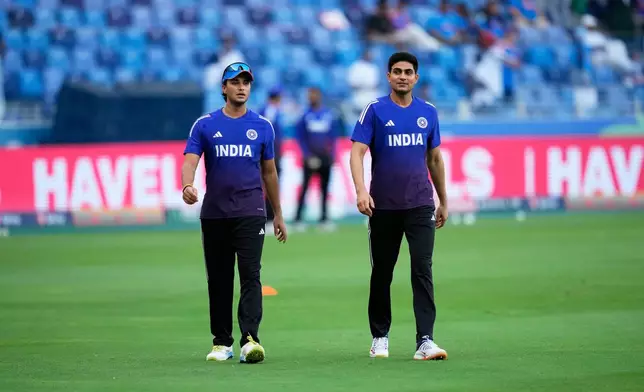 India's Abhishek Sharma, left, and teammate Shubman Gill have a chat before the start of the Asia Cup cricket final between India and Pakistan at Dubai International Cricket Stadium, United Arab Emirates, Sunday, Sept. 28, 2025. (AP Photo/Altaf Qadri)