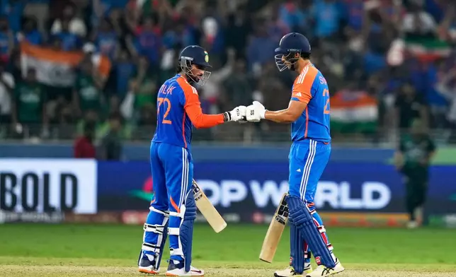 India's Tilak Varma, left, and batting partner Shivam Dube touch gloves during the Asia Cup cricket final between India and Pakistan at Dubai International Cricket Stadium, United Arab Emirates, Sunday, Sept. 28, 2025. (AP Photo/Altaf Qadri)