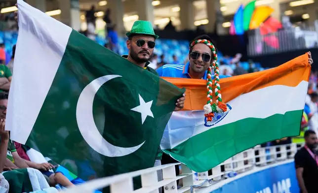India's and Pakistan's fans carry their national flags as they wait for the Asia Cup cricket final between India and Pakistan to begin at Dubai International Cricket Stadium, United Arab Emirates, Sunday, Sept. 28, 2025. (AP Photo/Altaf Qadri)