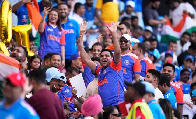 India's fans cheer for their team before the start of the Asia Cup cricket final between India and Pakistan to begin at Dubai International Cricket Stadium, United Arab Emirates, Sunday, Sept. 28, 2025. (AP Photo/Altaf Qadri)