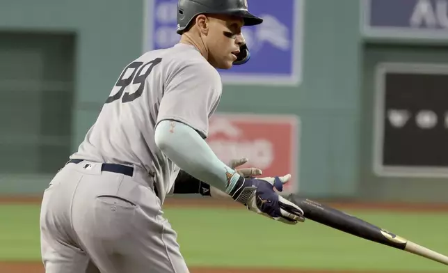 New York Yankees designated hitter Aaron Judge drops the bat after hitting a home run during the first inning of a baseball game against the Boston Red Sox, Friday, Sept. 12, 2025, in Boston. (AP Photo/Mark Stockwell)