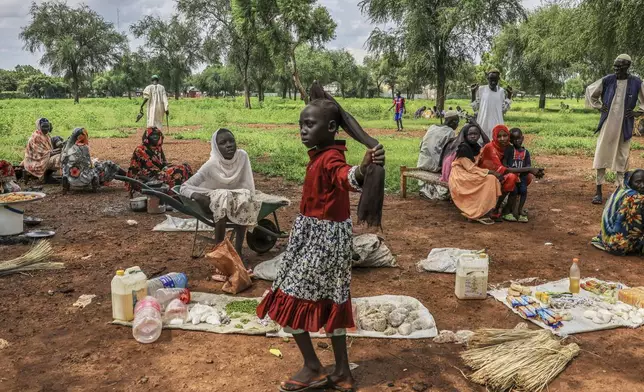 Women sell goods at a small market in the Gendrassa Refugee Camp, Maban, South Sudan, Wednesday, Aug. 20, 2025. (AP Photo/Caitlin Kelly)