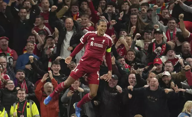 Liverpool's Virgil van Dijk celebrates after scoring his side's third goal during the Champions League opening phase soccer match between Liverpool and Atletico Madrid at Anfield stadium in Liverpool, England, Wednesday, Sept. 17, 2025. (AP Photo/Jon Super)