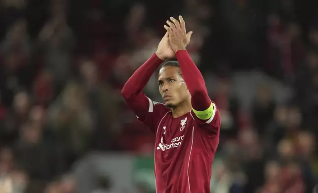 Liverpool's Virgil van Dijk waves supporters at the end of the Champions League opening phase soccer match between Liverpool and Atletico Madrid at Anfield stadium in Liverpool, England, Wednesday, Sept. 17, 2025. (AP Photo/Jon Super)