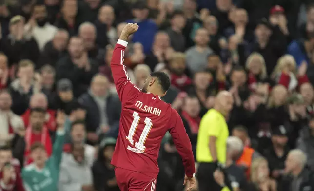 Liverpool's Mohamed Salah celebrates after scoring his side's second goal during the Champions League opening phase soccer match between Liverpool and Atletico Madrid at Anfield stadium in Liverpool, England, Wednesday, Sept. 17, 2025. (AP Photo/Jon Super)
