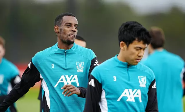 Liverpool's Alexander Isak, left, and Wataru Endo during a training session at the AXA Training Centre, Liverpool, England, Tuesday Sept. 16, 2025. (Peter Byrne/PA via AP)